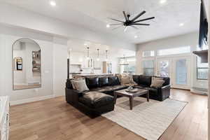 Living area featuring ceiling fan, light wood finished floors, and recessed lighting