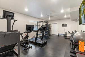 Workout area featuring a ceiling fan and recessed lighting
