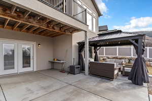Patio / terrace featuring a patio area, outdoor furniture, french doors, and a gazebo