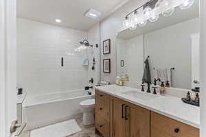 Full bathroom featuring vanity, shower / bath combination with glass door, and recessed lighting