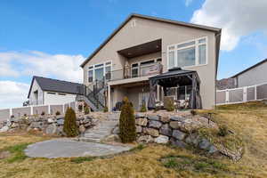 Rear view of property with a patio area, stucco siding, a gate, and a fenced backyard