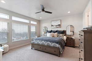 Bedroom with light carpet, a ceiling fan, and recessed lighting