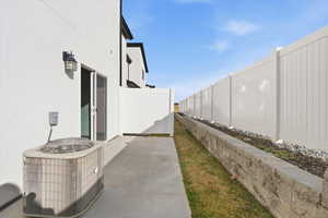View of property exterior with stucco siding and a patio