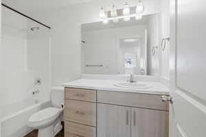Full bath featuring shower / bath combination and vanity