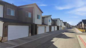 View of asphalt road with a residential view and sidewalks