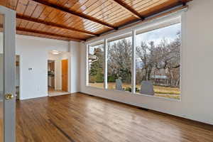 Front room with floor to ceiling windows and original hardwood floors