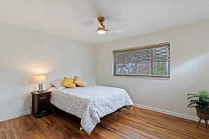 large bedroom with original hardwood floors, closet with builtins
