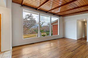 Huge front room with 8 ft windows and vaulted, real wood ceilings