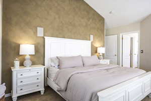 Bedroom featuring dark carpet