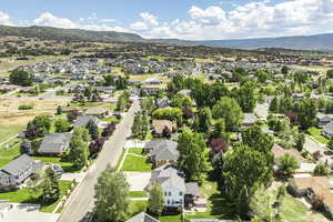 Aerial view of residential area featuring a mountainous background