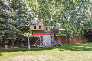 View of jungle gym with a fenced backyard