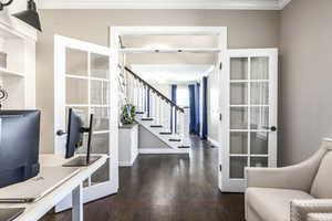 Office featuring dark wood-style flooring and crown molding
