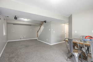 Finished basement with carpet and a textured ceiling