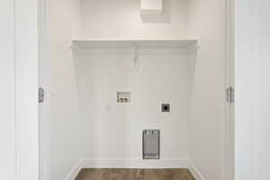Laundry area with wood finished floors, hookup for a washing machine, and electric dryer hookup