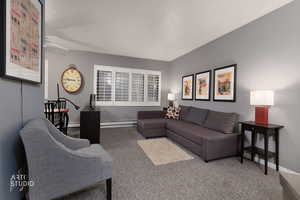 Living room featuring baseboard heating and carpet flooring
