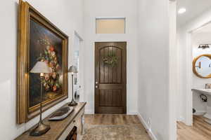 Entrance foyer with light wood-style flooring and baseboards