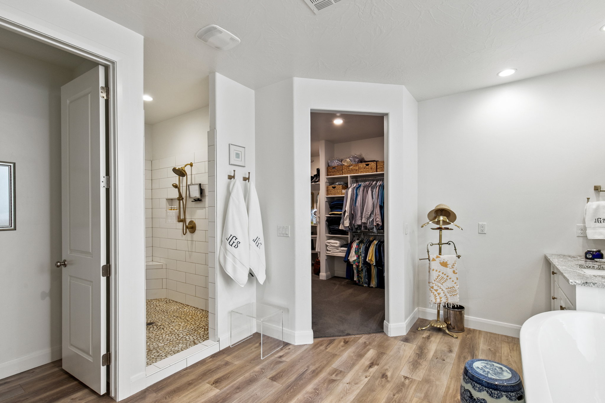 Bathroom with a spacious closet, walk in shower, light wood-style flooring, vanity, and recessed lighting