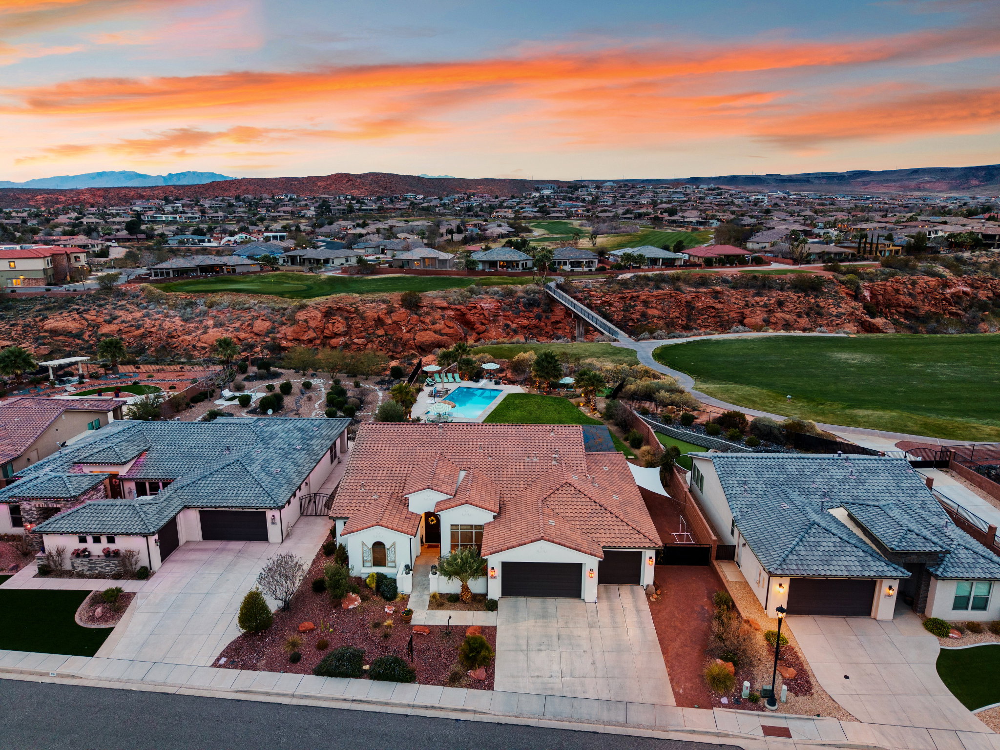 Aerial view at dusk of a residential view, a mountain view, and golf course view