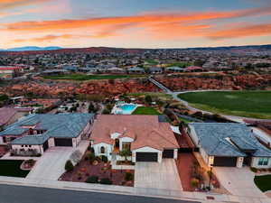 Aerial view at dusk of a residential view, a mountain view, and golf course view