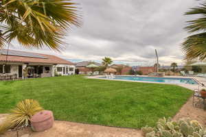 View of swimming pool featuring patio surround and a fenced backyard