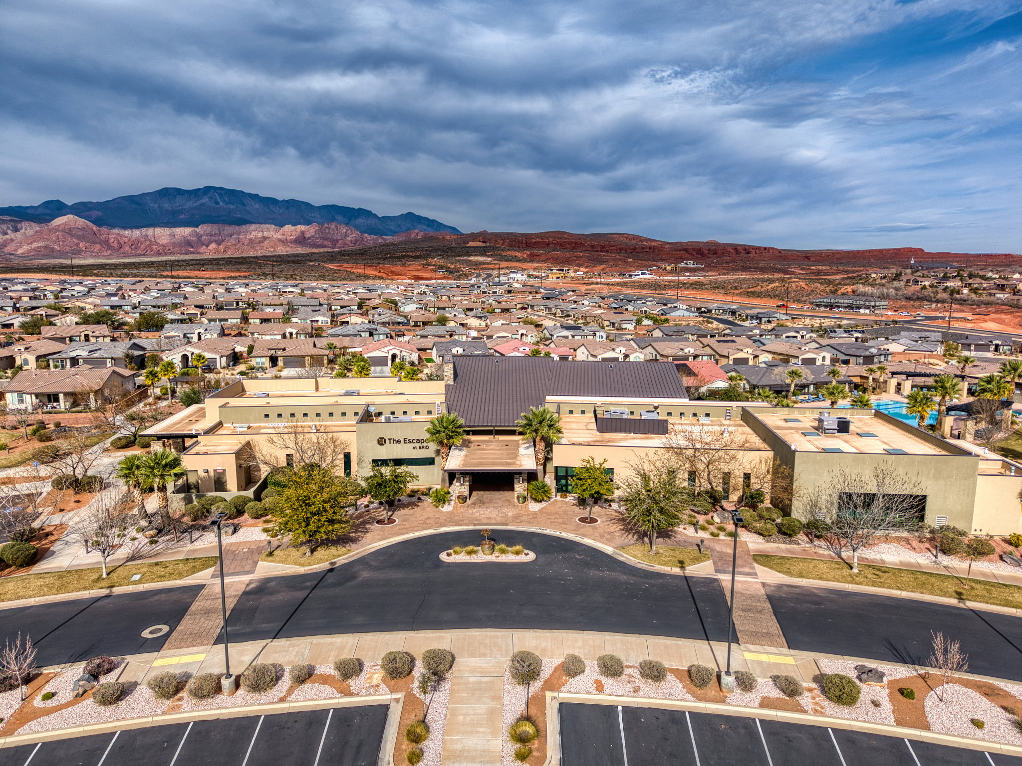 Aerial perspective of suburban area with a mountainous background