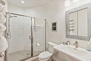 Bathroom with a shower stall and toilet