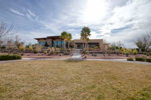 View of front facade with a front lawn and stucco siding