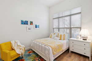 Bedroom with wood finished floors and baseboards