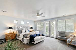 Carpeted bedroom featuring access to outside, french doors, and ceiling fan