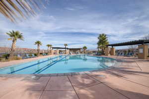 Community pool with a patio area and a pergola