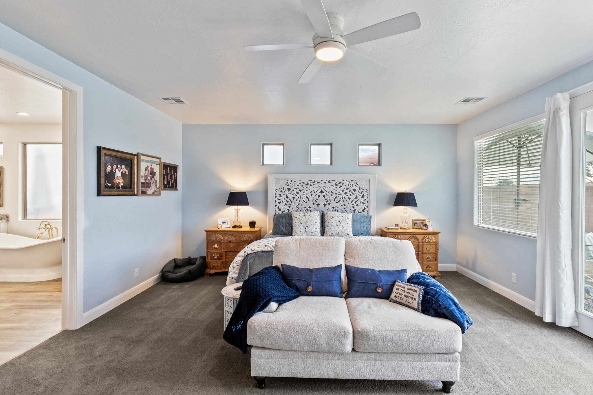 Bedroom featuring carpet flooring, a ceiling fan, ensuite bath, and access to exterior