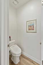 Bathroom featuring baseboards and wood finished floors