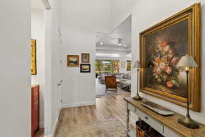 Corridor featuring light wood finished floors and recessed lighting