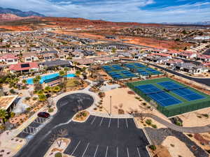 Aerial view of residential area with mountains and a pool