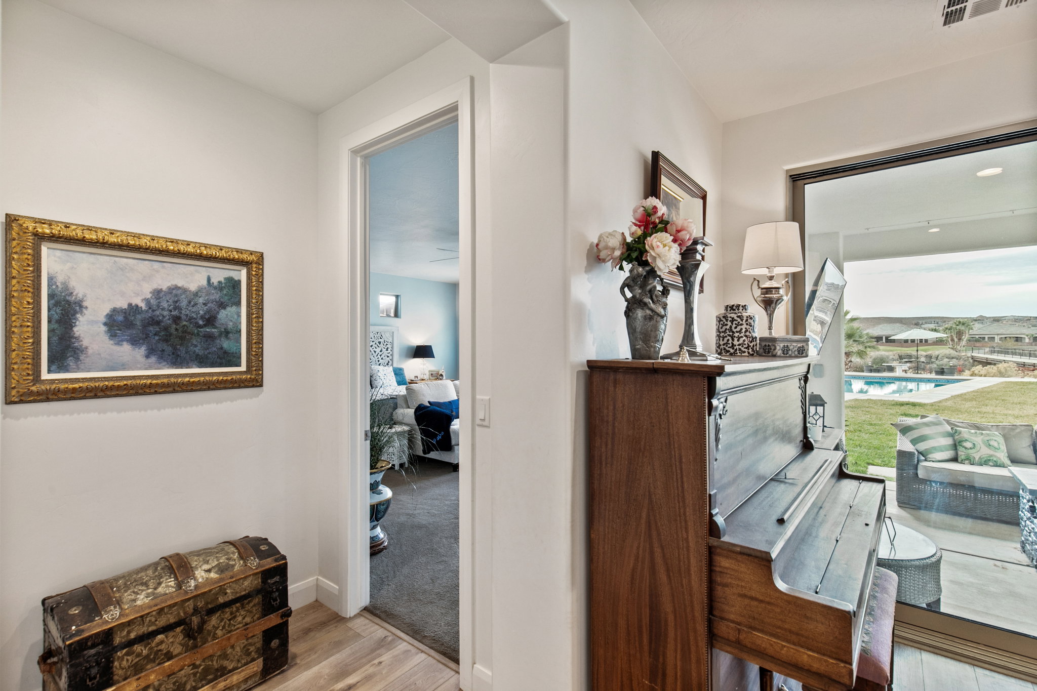 Hallway with light wood-type flooring and light colored carpet
