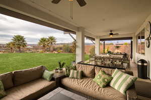 Fenced backyard featuring ceiling fan, a patio area, and outdoor lounge area