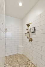 Bathroom featuring tiled shower