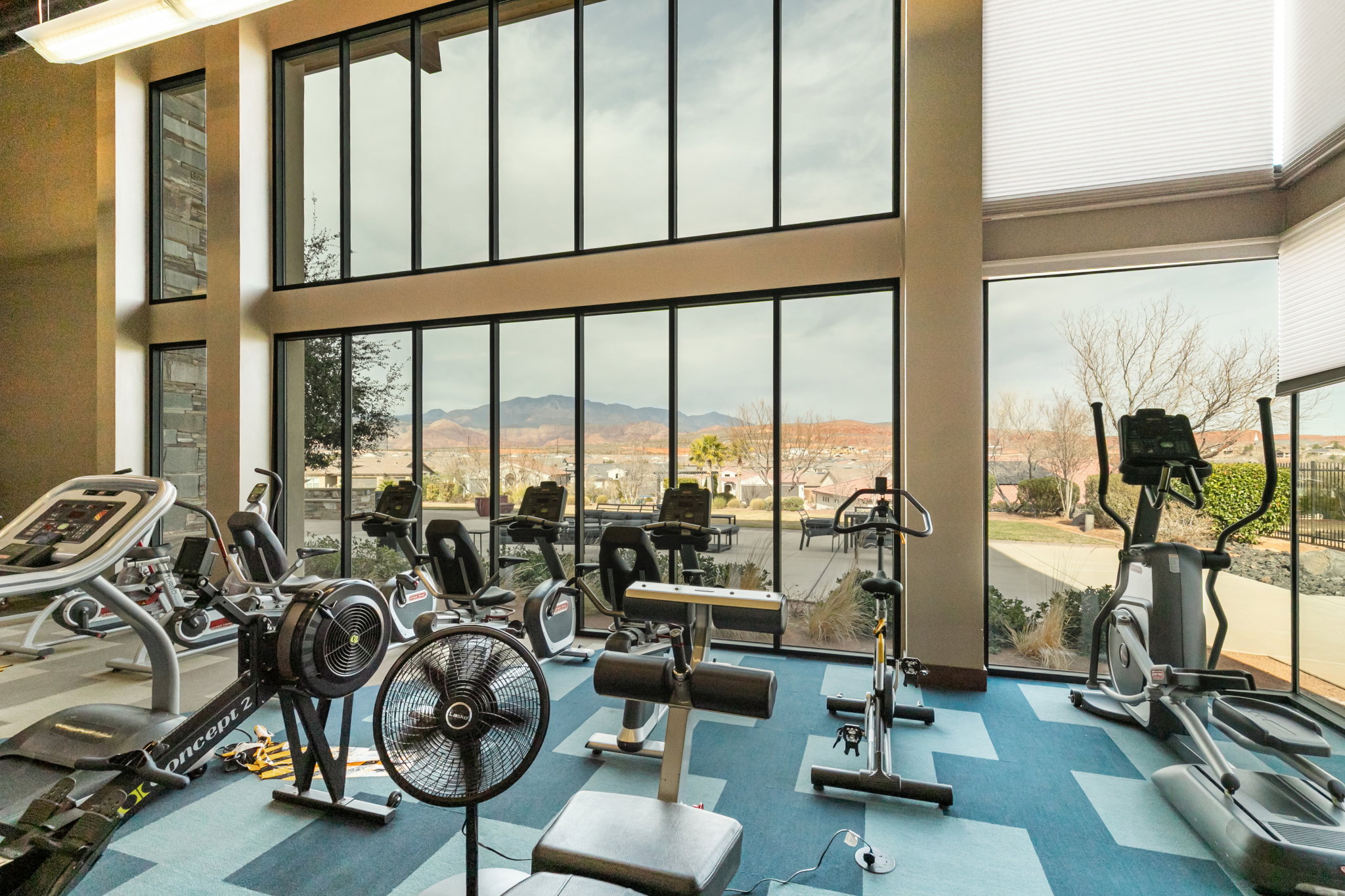 Workout area featuring a mountain view and a high ceiling
