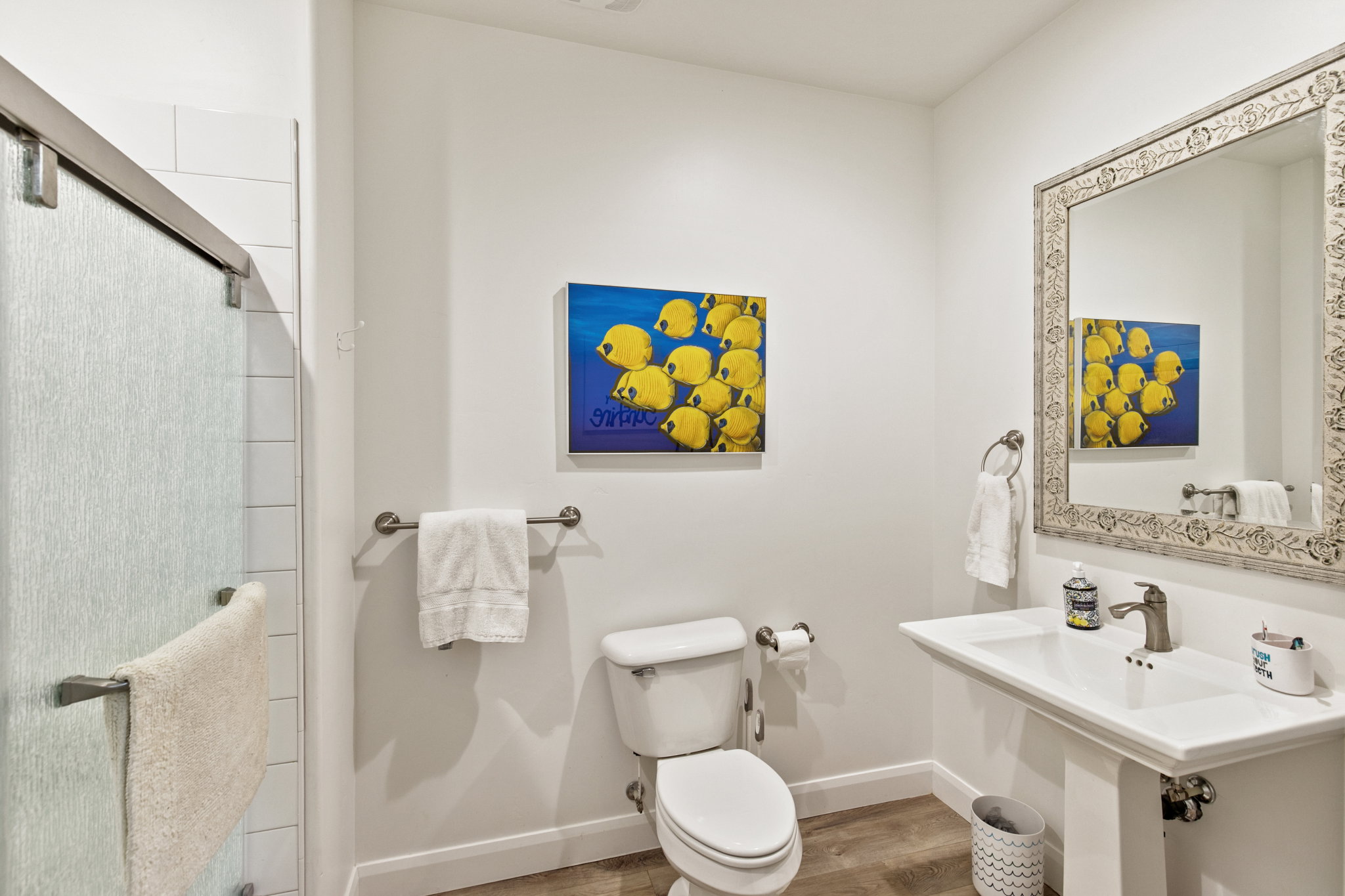 Full bathroom featuring a shower stall and wood finished floors