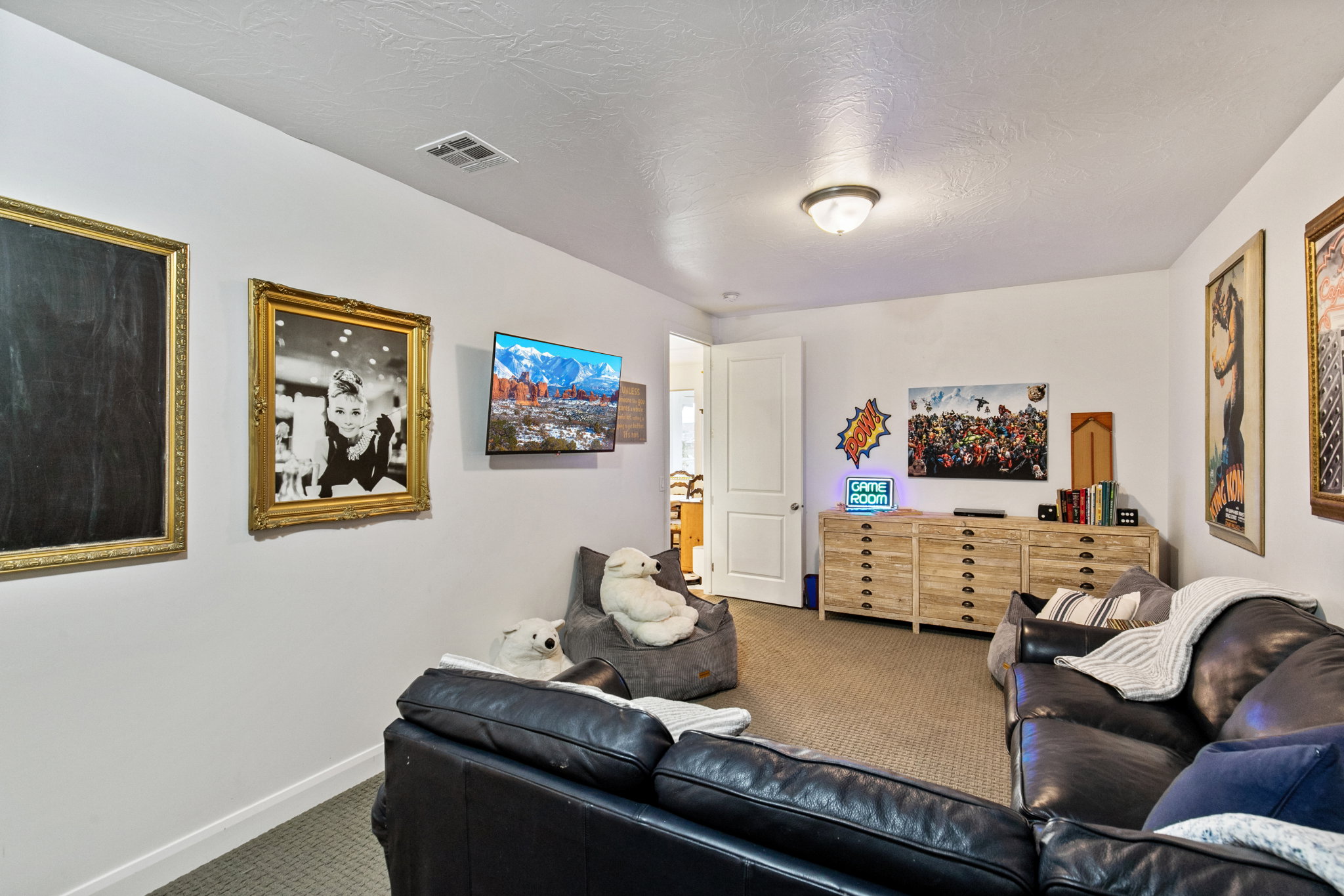 Carpeted living room with baseboards and a textured ceiling