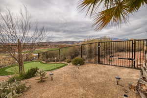 View of yard featuring an area to practice putting and a mountain view