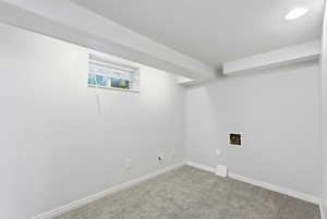 Below grade area with baseboards and carpet floors