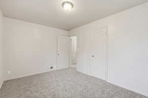 Unfurnished bedroom featuring carpet flooring and baseboards
