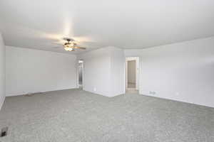 Spare room with ceiling fan and light colored carpet