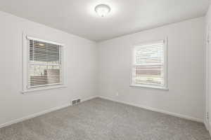 Empty room with baseboards and carpet floors