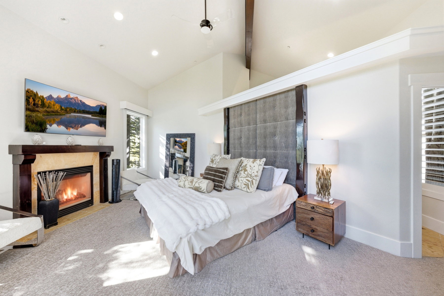 Vaulted ceiling with an exposed beam, recessed lighting, and a ceiling fan