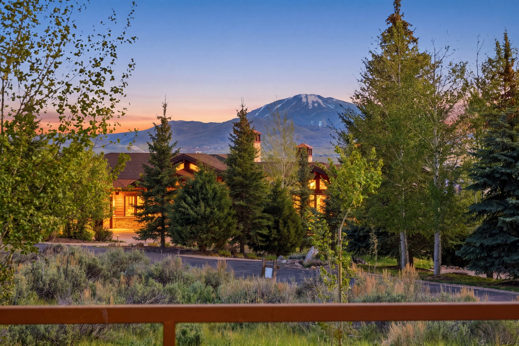 Rustic-style residence featuring a prominent stone foundation and wood siding