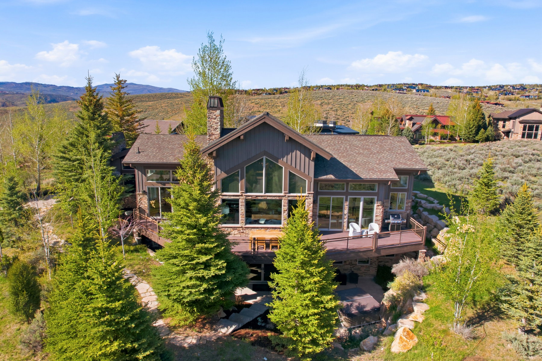 Contemporary mountain-style residence featuring stone and wood siding