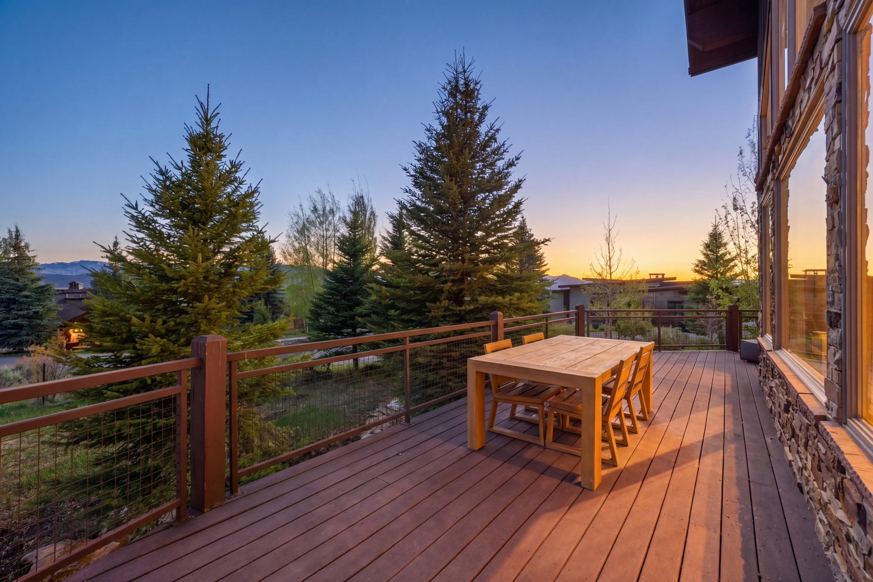 Expansive outdoor deck featuring wood-finish flooring and a cable railing system