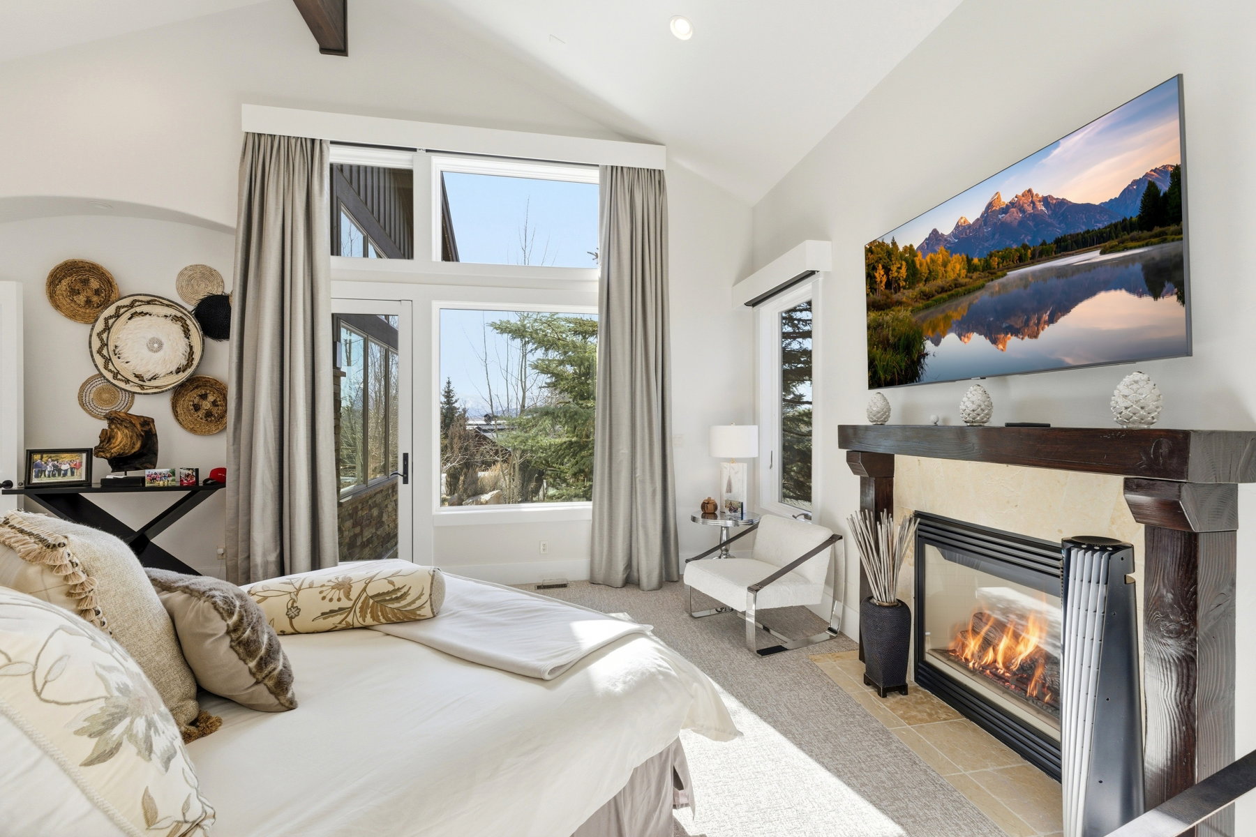 Vaulted ceiling interior featuring a built-in fireplace with a dark wood mantel and light-colored surround